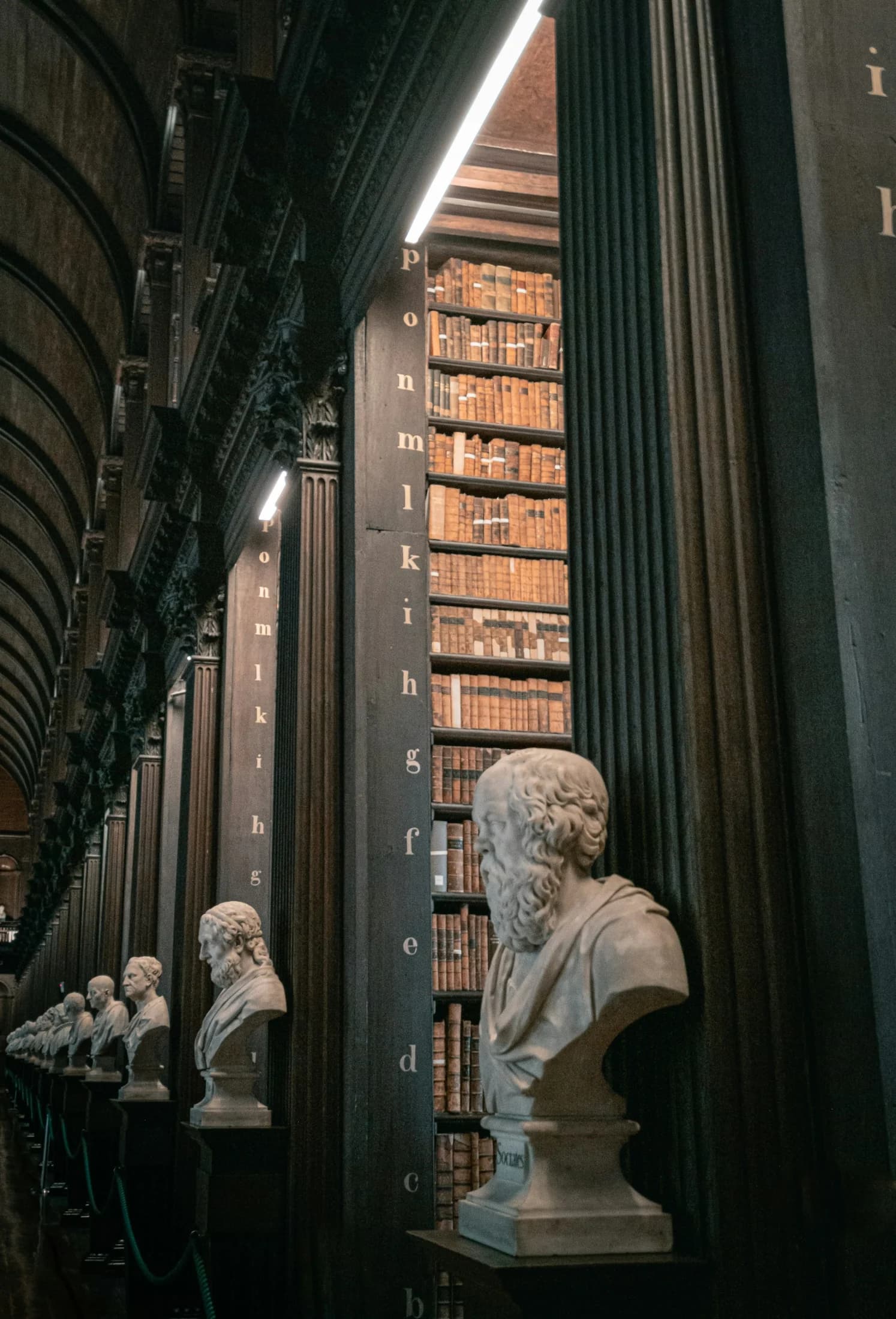 Historic bookshelves inside Trinity College Library in Dublin
